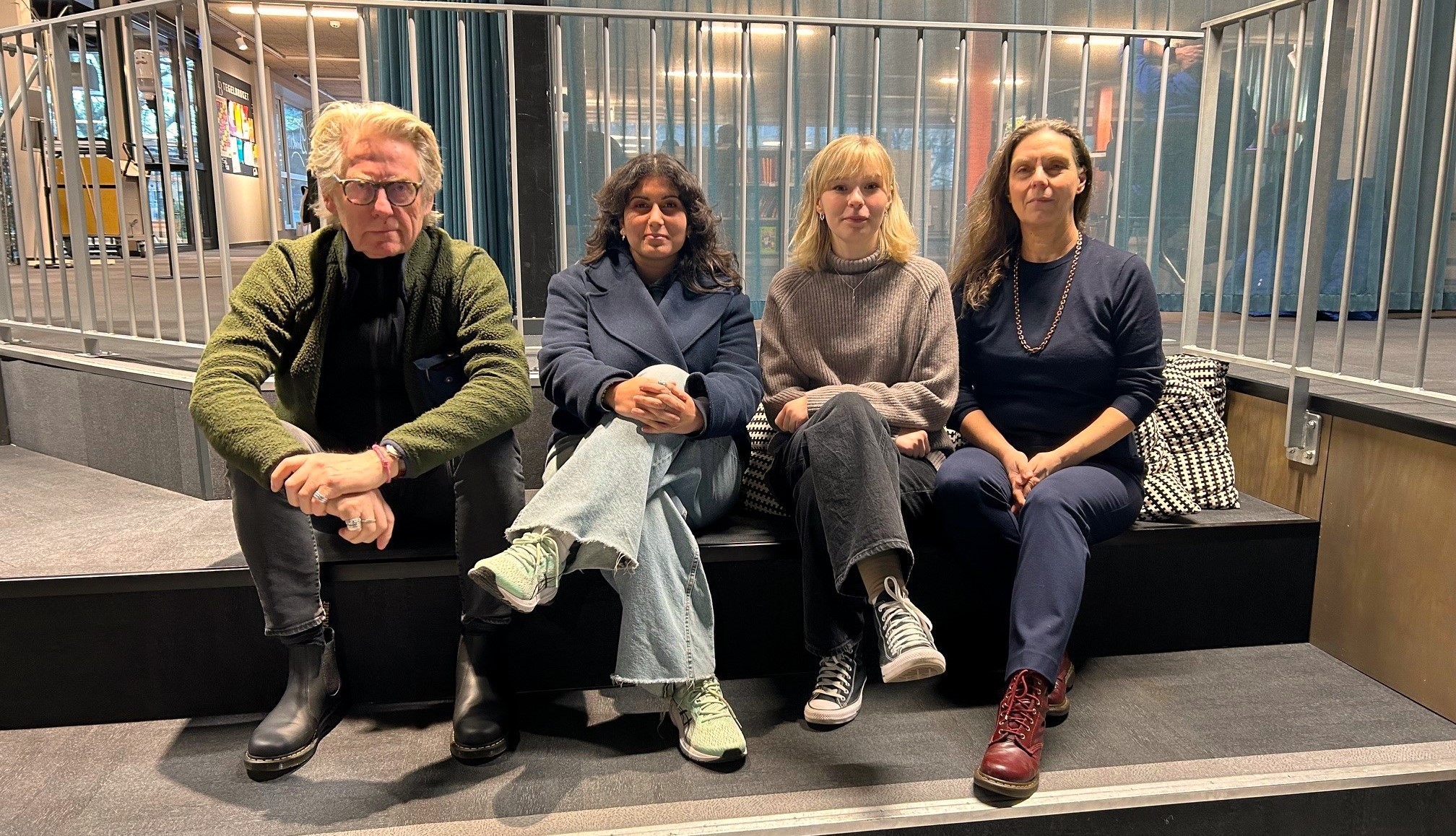 Fyra personer sitter på rad bredvid varandra och kollar in i kameran. Det är jurymedlemmarna för tävlingen Writeit. 